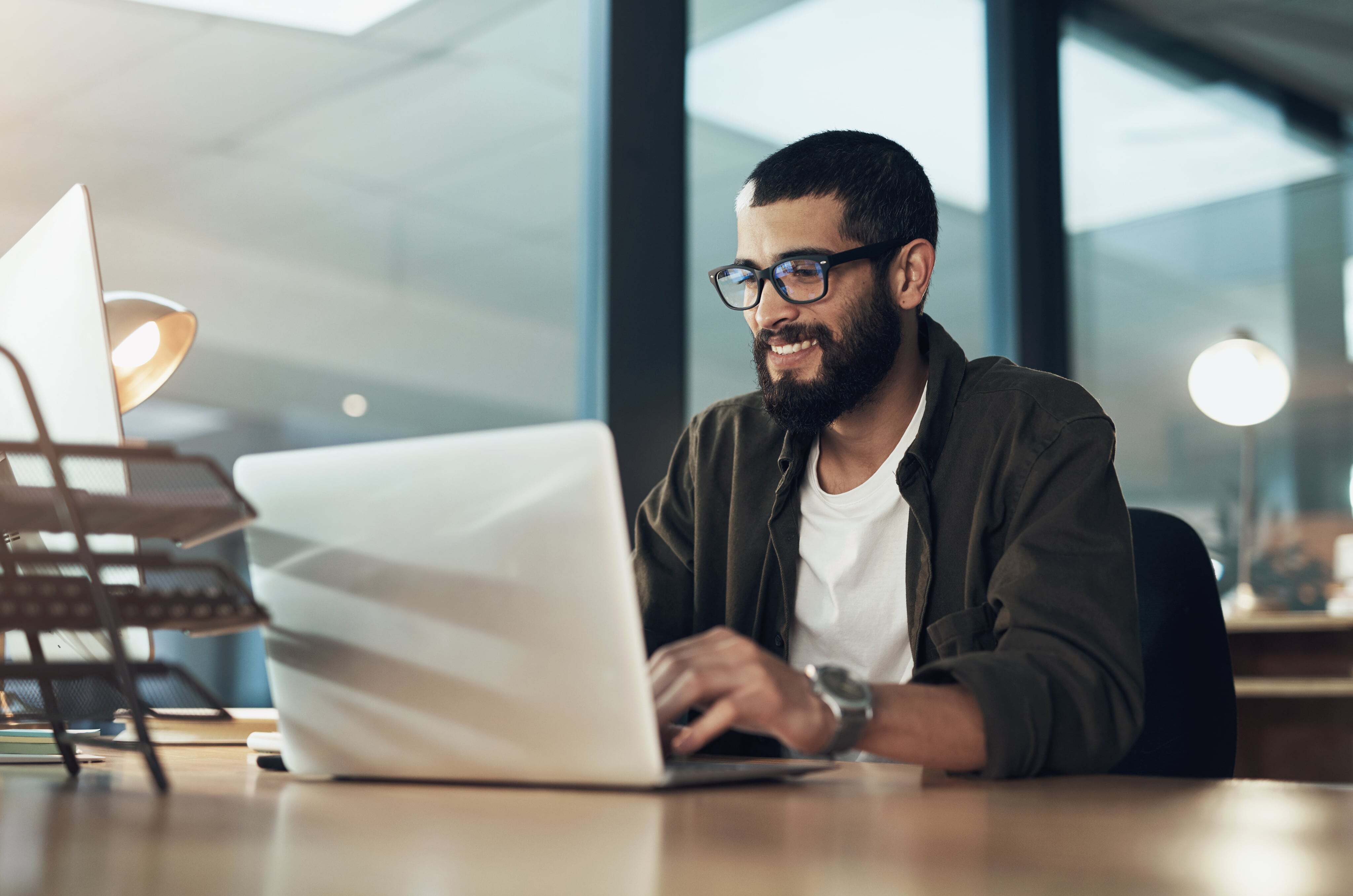 Man working on laptop in modern office